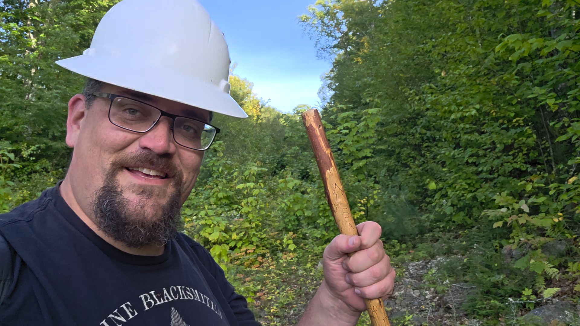Sam Smith prospecting along a wooded Maine claim